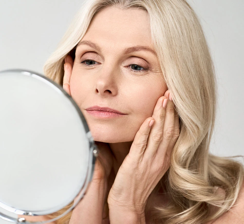 Woman admiring her face | New You Plastic Surgery in New York
