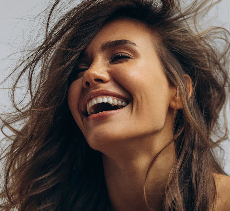 woman laughing | New You Plastic Surgery in New York
